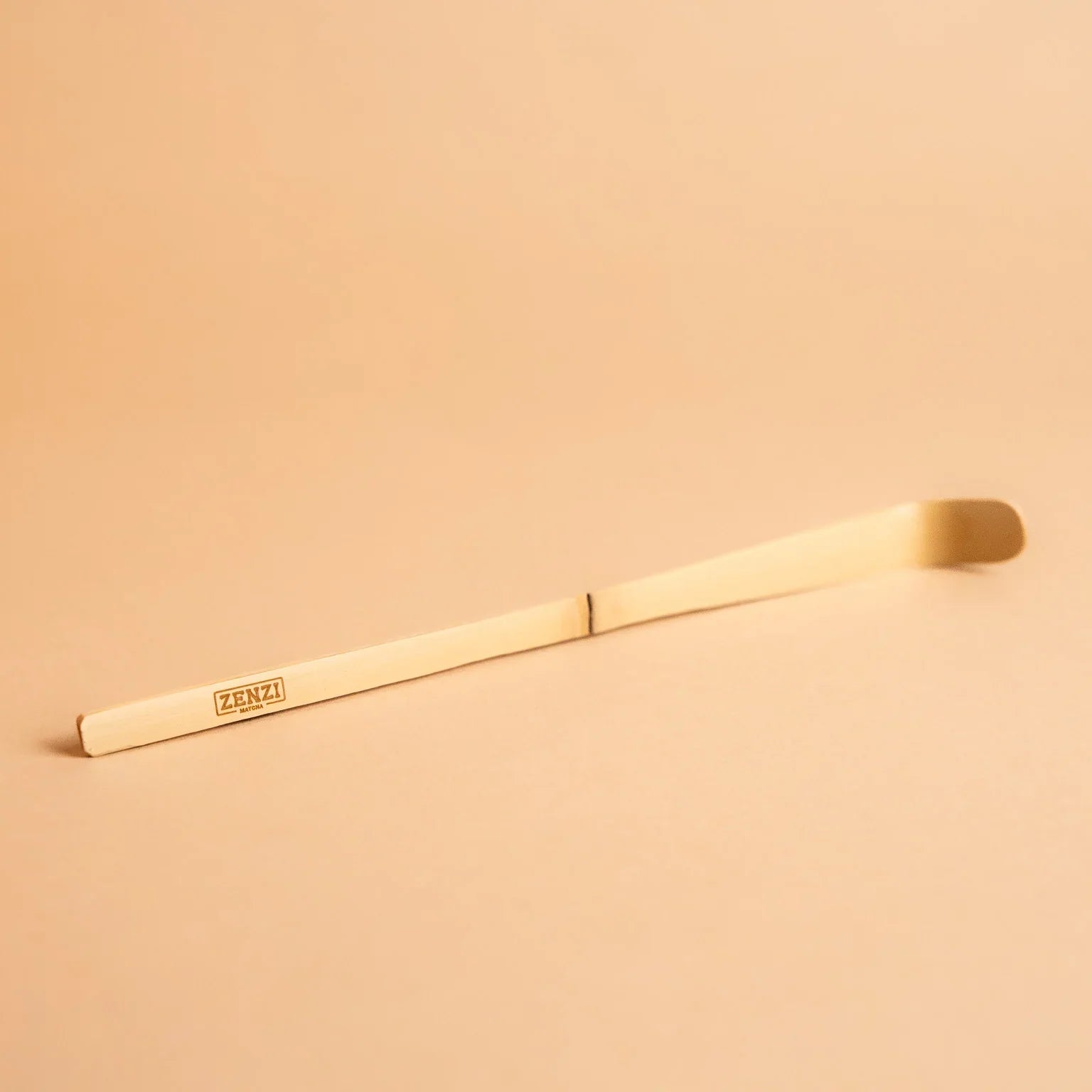 bamboo matcha scoop chashaku on beige background, used for Japanese tea ceremony